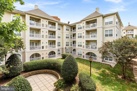 a front view of a residential apartment building with a yard