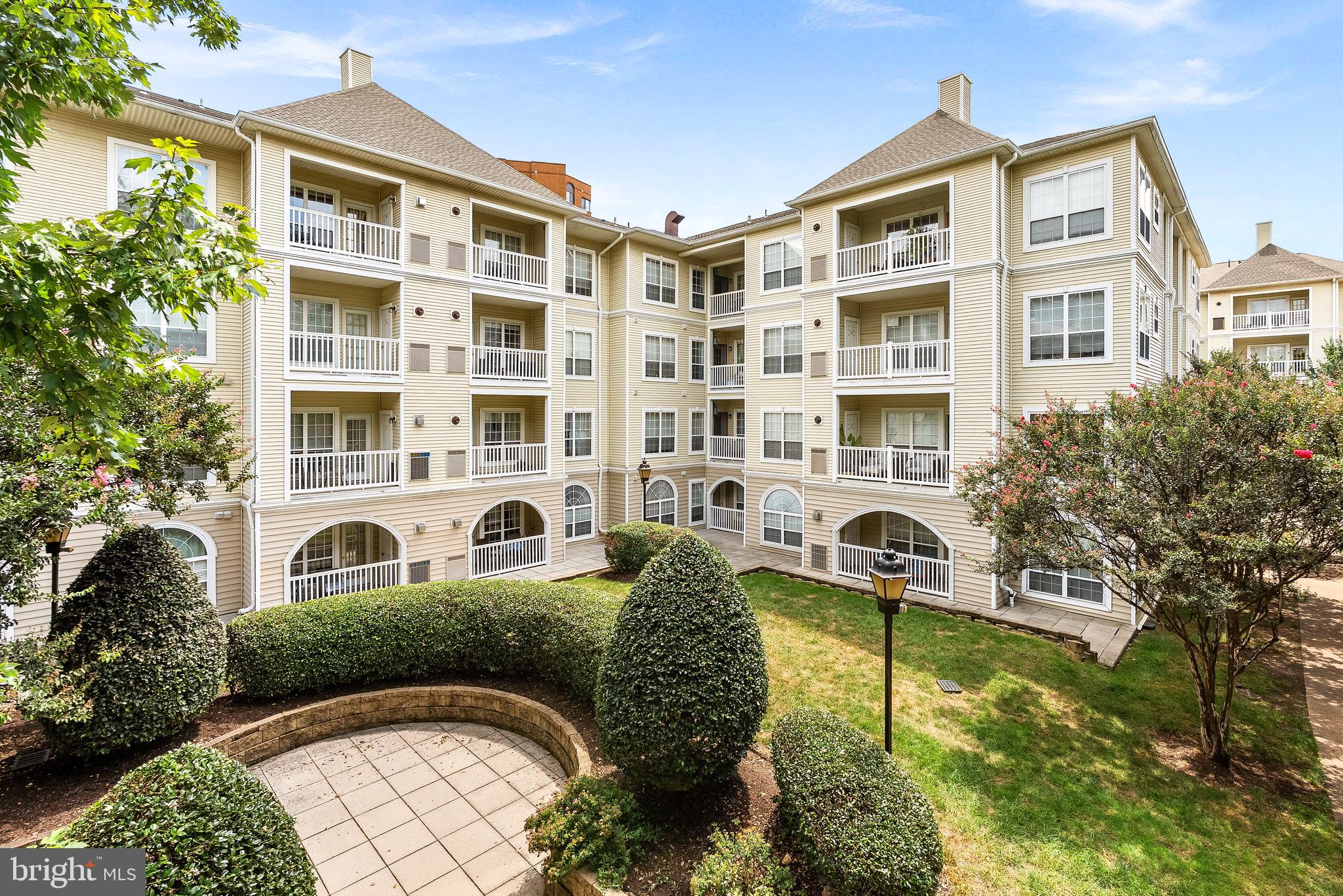 4551 Strutfield Lane, Unit 4111 Alexandria, VA 22311 - Photo 31 of 35 a front view of a residential apartment building with a yard