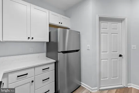a kitchen with cabinets and stainless steel appliances