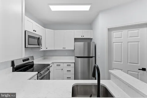 a kitchen with a refrigerator and a sink