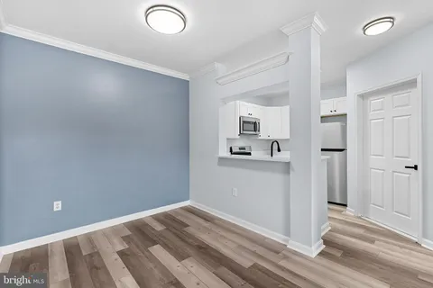 a view of a kitchen with wooden floor and a sink