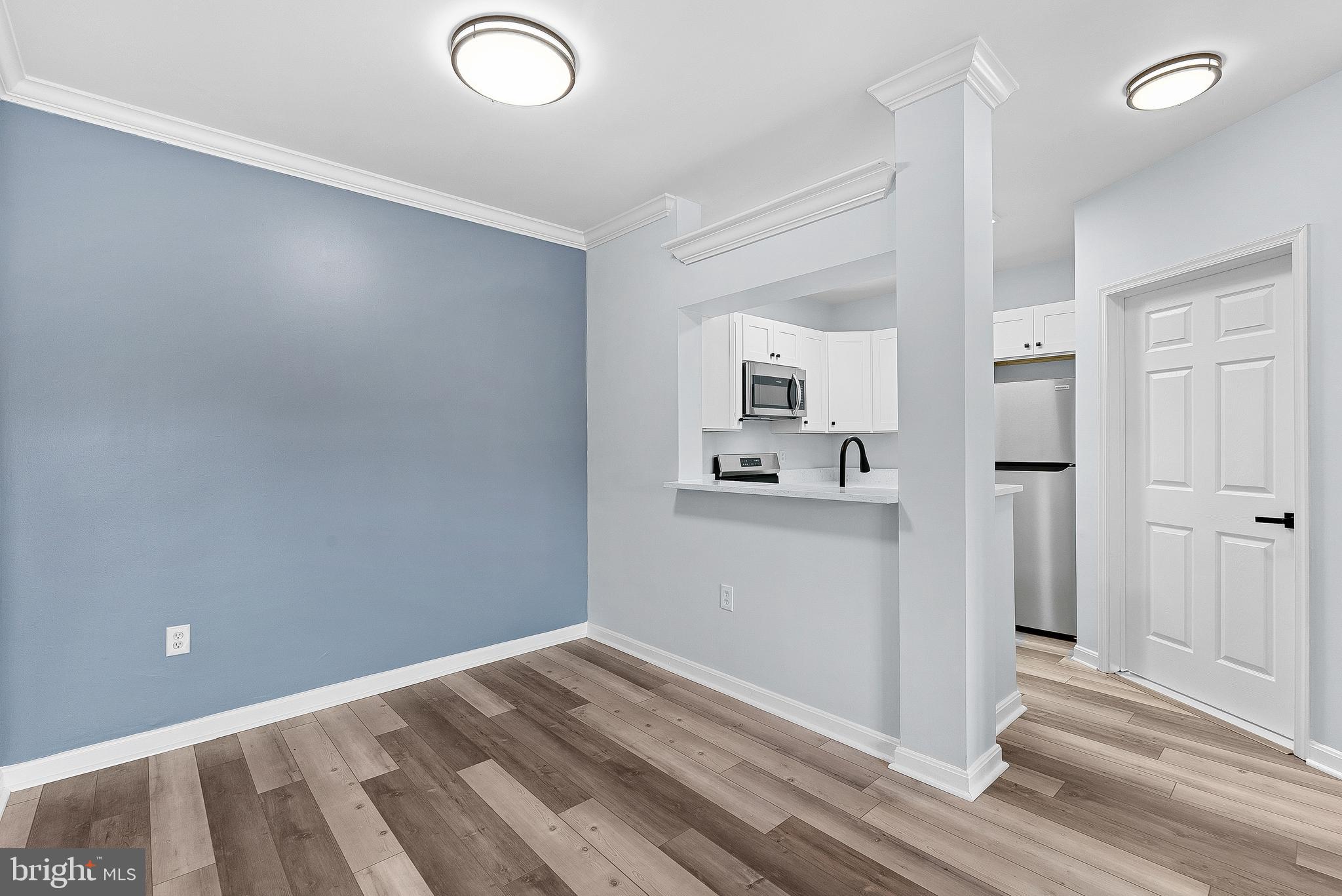 4551 Strutfield Lane, Unit 4111 Alexandria, VA 22311 - Photo 8 of 35 a view of a kitchen with wooden floor and a sink