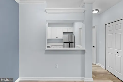 a living room with a sink and a refrigerator
