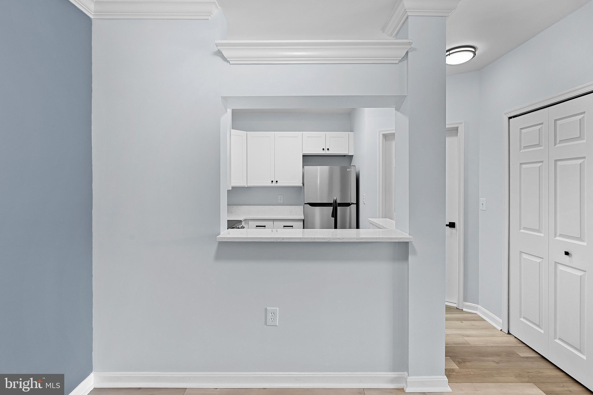 4551 Strutfield Lane, Unit 4111 Alexandria, VA 22311 - Photo 10 of 35 a living room with a sink and a refrigerator