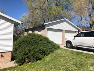 1615 Pioneer Road Draper, UT 84020 - Photo 12 of 13 Detached two-car garage with white paneled garage doors, white siding, and a concrete driveway