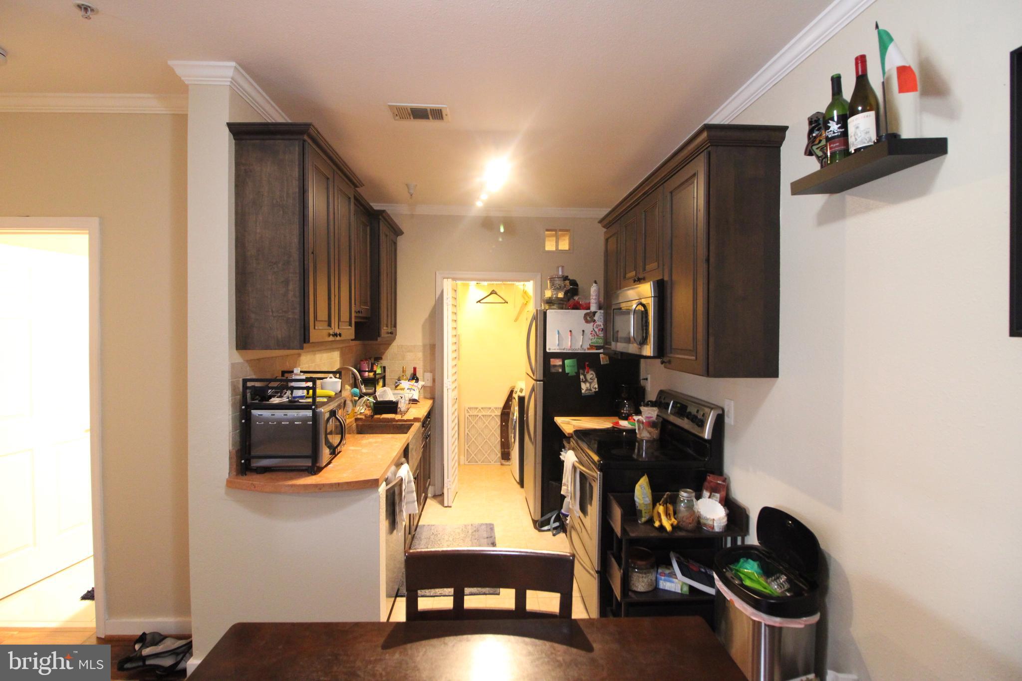 1570 Spring Gate Dr., Unit 7113 McLean, VA 22102 - Photo 6 of 8 a view of a workspace with furniture and wooden floor