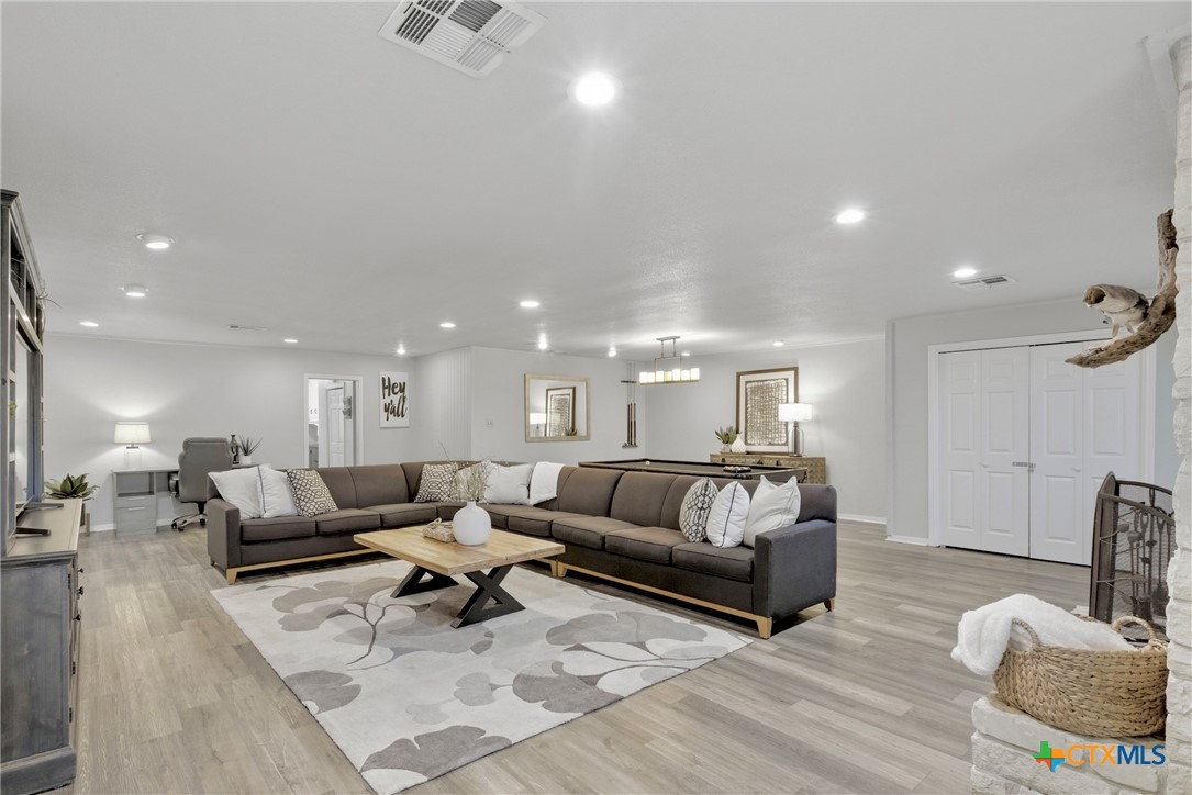1710 Old Mill Road, Unit 12 Salado, TX 76571 - Photo 22 of 42 a living room with furniture and wooden floor