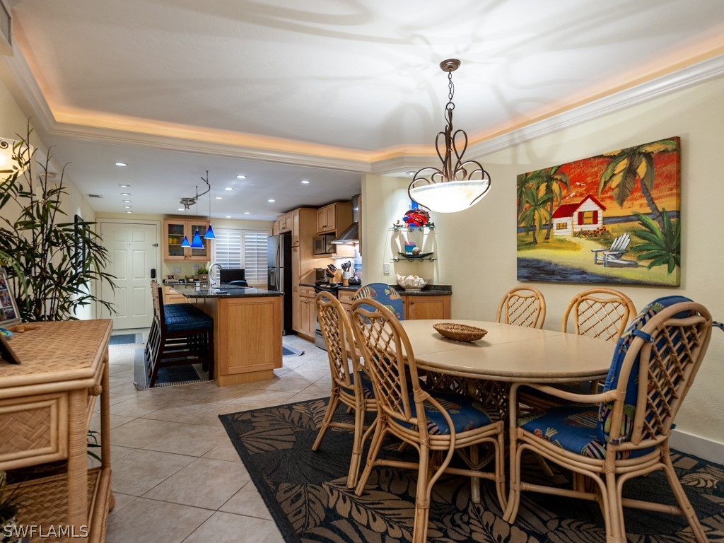 2445 West Gulf Drive, Unit E2 Sanibel, FL 33957 - Photo 12 of 35 a dining room with furniture and window