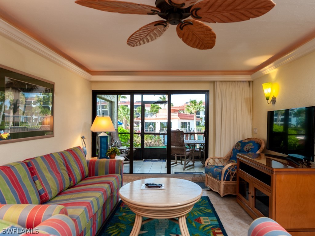2445 West Gulf Drive, Unit E2 Sanibel, FL 33957 - Photo 15 of 35 a living room with furniture a rug and a flat screen tv