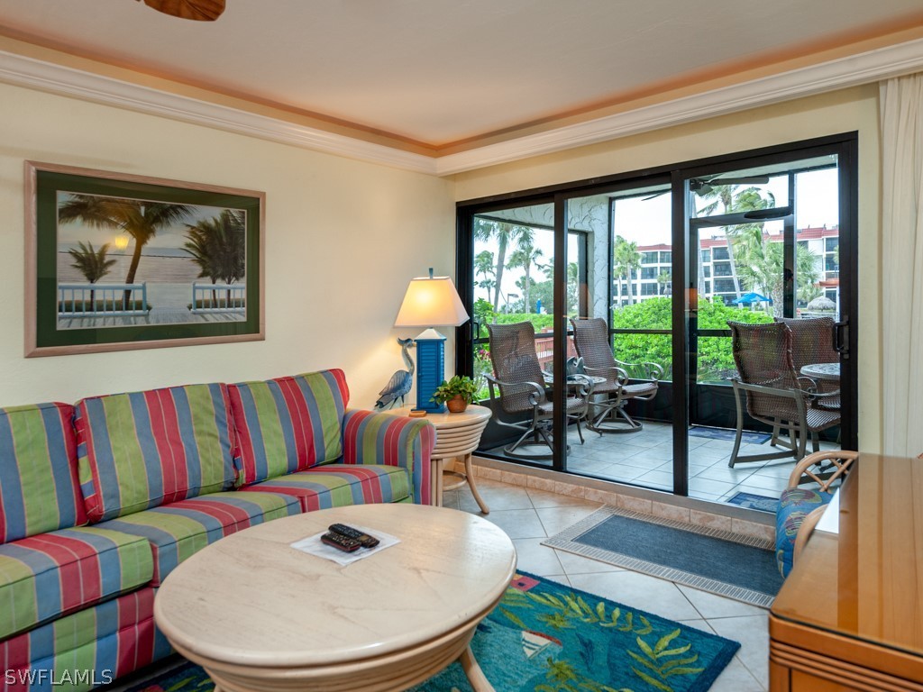 2445 West Gulf Drive, Unit E2 Sanibel, FL 33957 - Photo 16 of 35 a living room with furniture and a large window