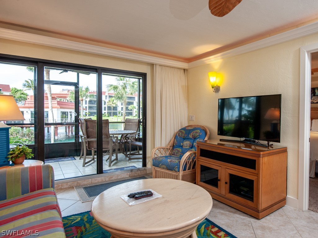 2445 West Gulf Drive, Unit E2 Sanibel, FL 33957 - Photo 17 of 35 a living room with furniture and a flat screen tv