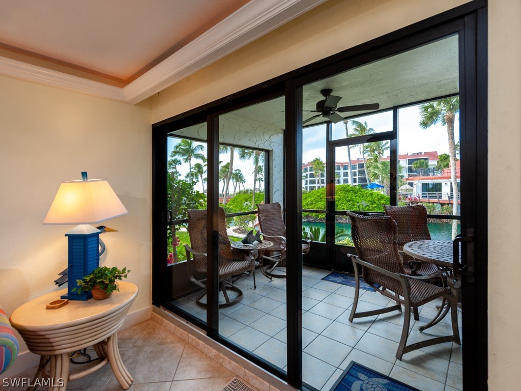 2445 West Gulf Drive, Unit E2 Sanibel, FL 33957 - Photo 18 of 35 a living room with furniture and a floor to ceiling window
