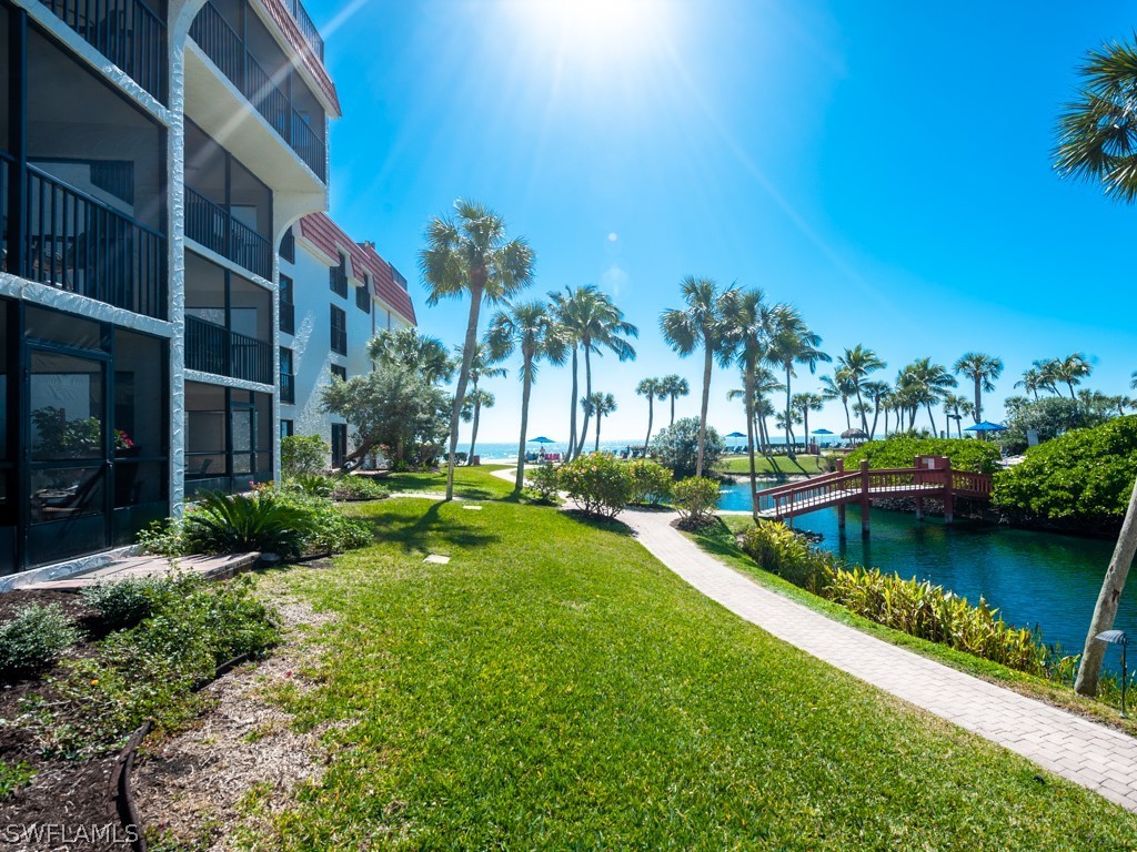 2445 West Gulf Drive, Unit E2 Sanibel, FL 33957 - Photo 20 of 35 a view of a swimming pool with a garden and plants