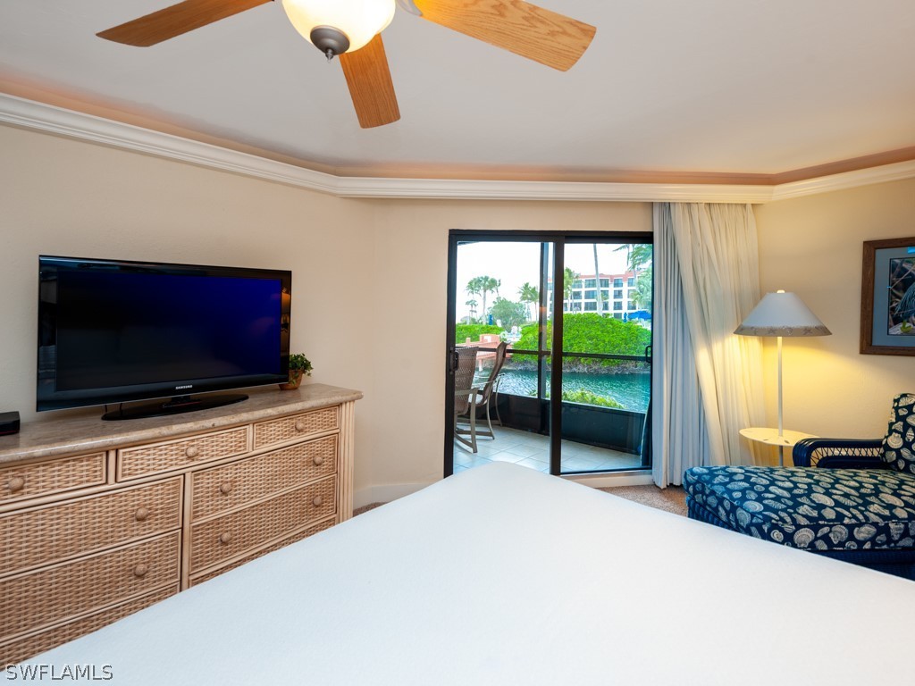 2445 West Gulf Drive, Unit E2 Sanibel, FL 33957 - Photo 22 of 35 a bedroom with a bed and a television