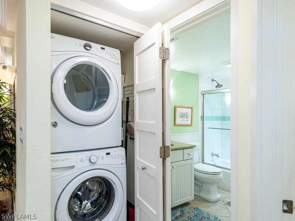 2445 West Gulf Drive, Unit E2 Sanibel, FL 33957 - Photo 27 of 35 a view of a bathroom with a washer and dryer
