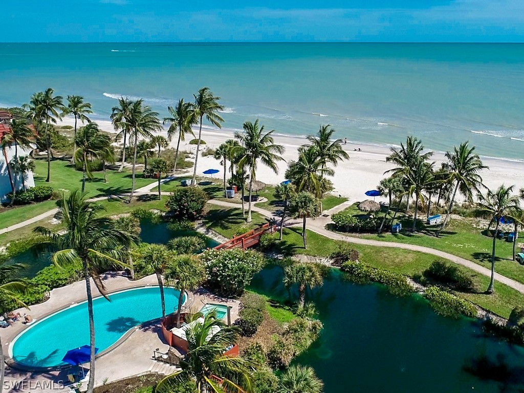 2445 West Gulf Drive, Unit E2 Sanibel, FL 33957 - Photo 3 of 35 a view of a lake with a building in the background