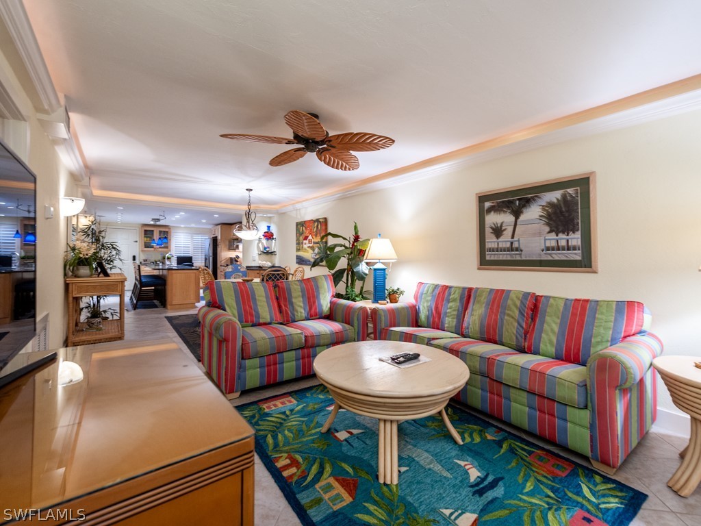 2445 West Gulf Drive, Unit E2 Sanibel, FL 33957 - Photo 4 of 35 a living room with furniture kitchen view and a chandelier