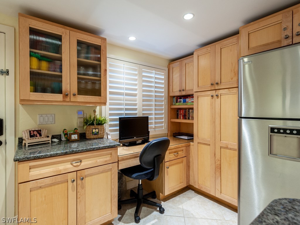 2445 West Gulf Drive, Unit E2 Sanibel, FL 33957 - Photo 8 of 35 a kitchen with stainless steel appliances granite countertop a refrigerator and a stove top oven