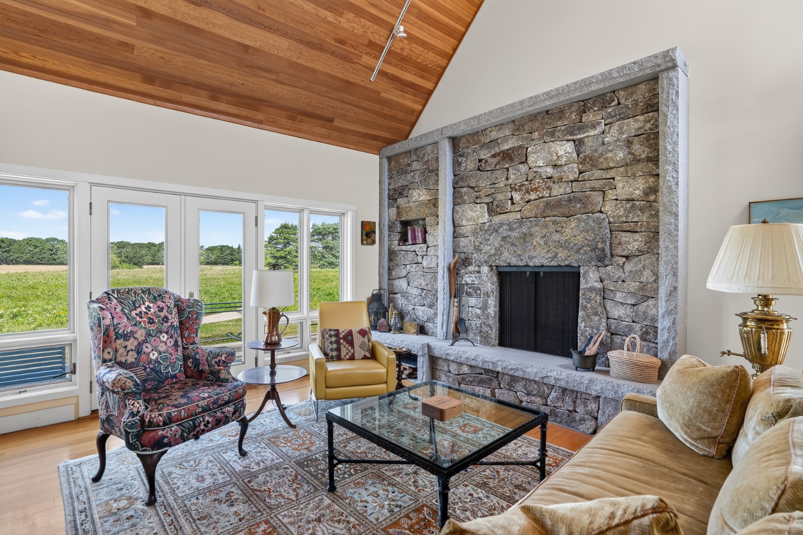 30 Elias Lane West Tisbury, MA 02568 - Photo 10 of 18 The living room features a Lew French stone fireplace.