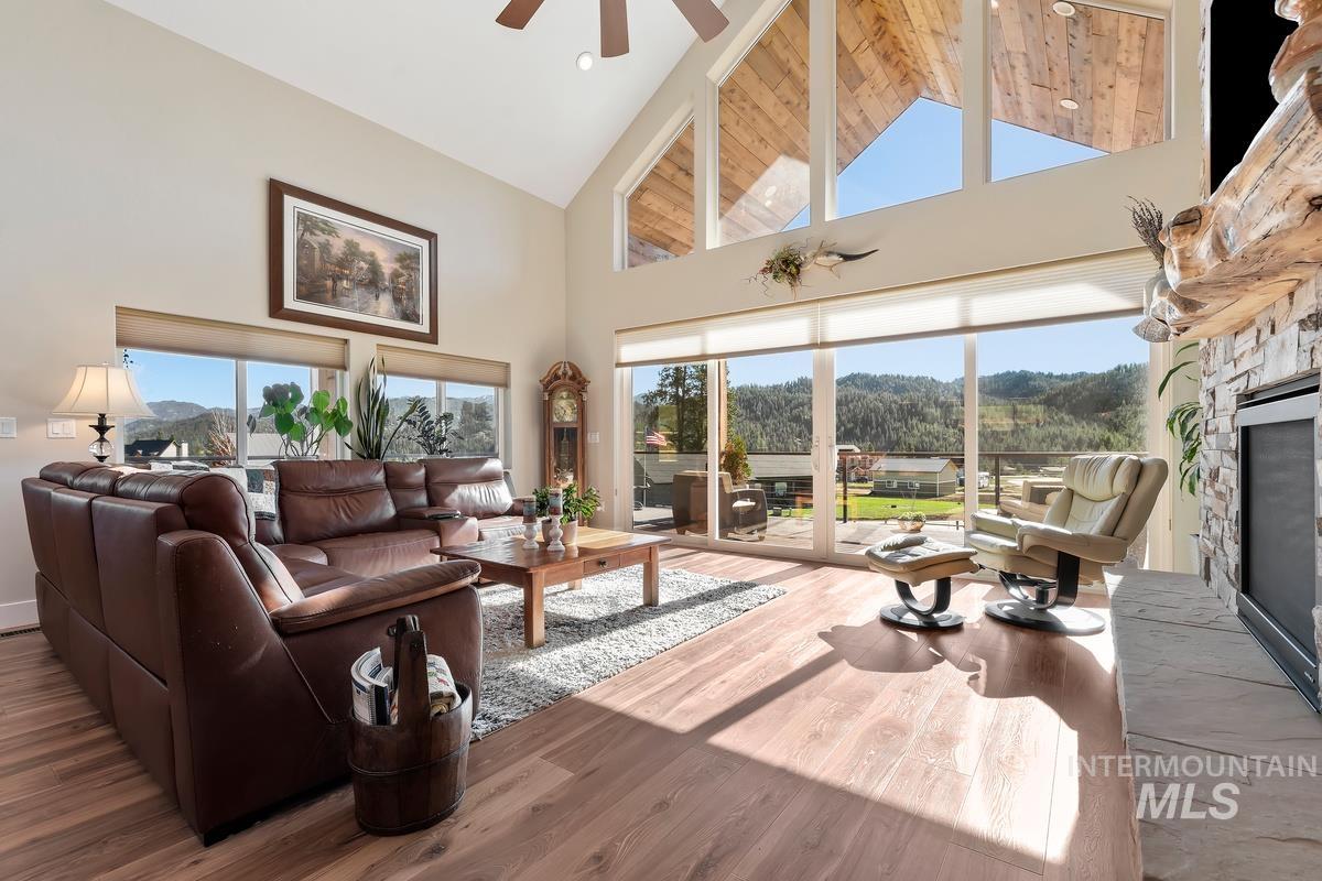 21 Open Road Garden Valley, ID 83622 - Photo 6 of 49 Living area with a fireplace, wood finished floors, a high ceiling, and a ceiling fan