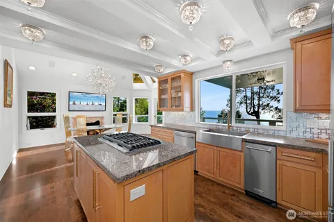 a kitchen with granite countertop stainless steel appliances a stove and a sink