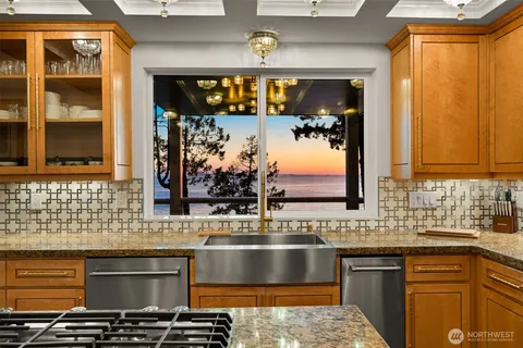 a kitchen with a sink and a stove top oven