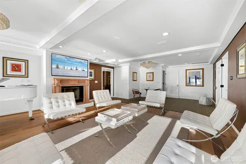 a living room with furniture a fireplace and a table