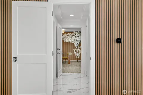 a view of a hallway with wooden shelves