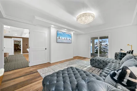 a bedroom with a large bed and a chandelier