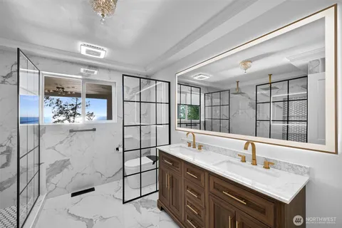 a bed room with a bed and a view of kitchen