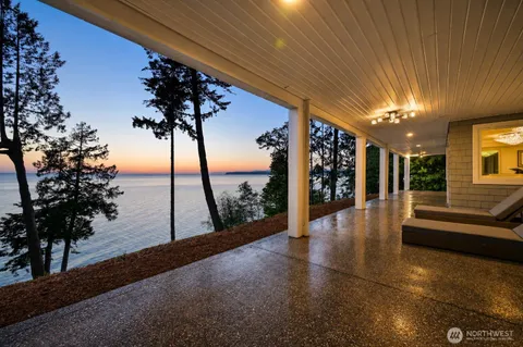 a balcony with wooden floor and outdoor seating