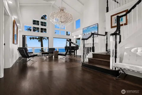 a living room with furniture gym equipment and a chandelier