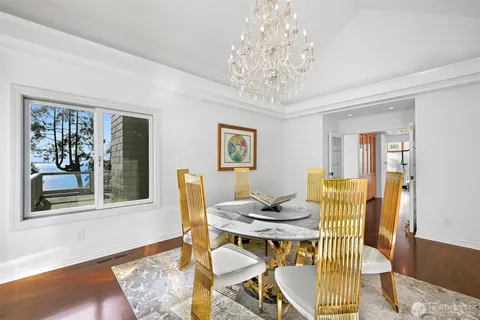 a view of a dining room with furniture and chandelier