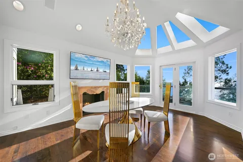 a view of a dining room with furniture wooden floor and chandelier