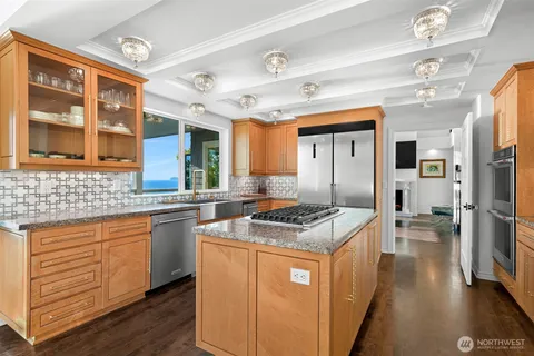 a kitchen with stainless steel appliances granite countertop a stove and a sink