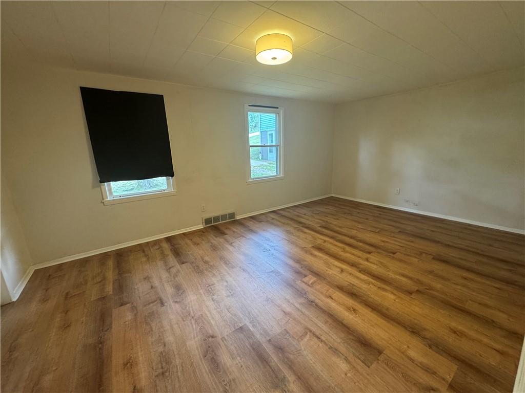 2 Willow Street McKees Rocks, PA 15136 - Photo 4 of 18 an empty room with wooden floor and windows