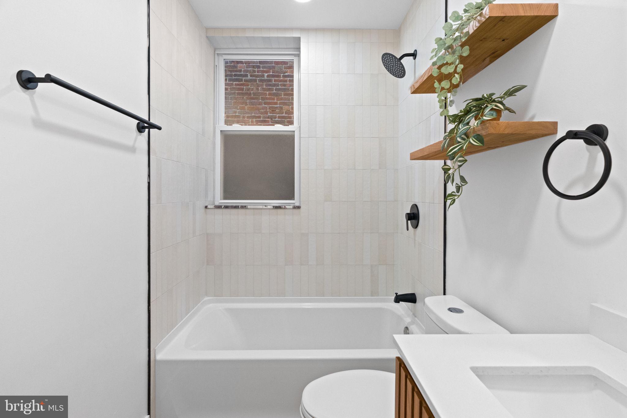 1502 South 52nd Street Philadelphia, PA 19143 - Photo 13 of 34 a bathroom with a toilet a sink and a bathtub
