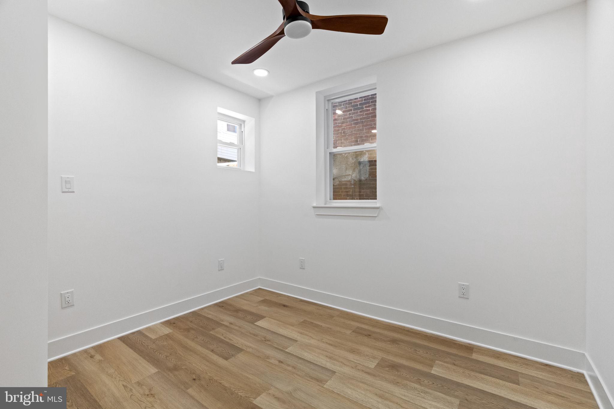 1502 South 52nd Street Philadelphia, PA 19143 - Photo 16 of 34 an empty room with a window and ceiling fan