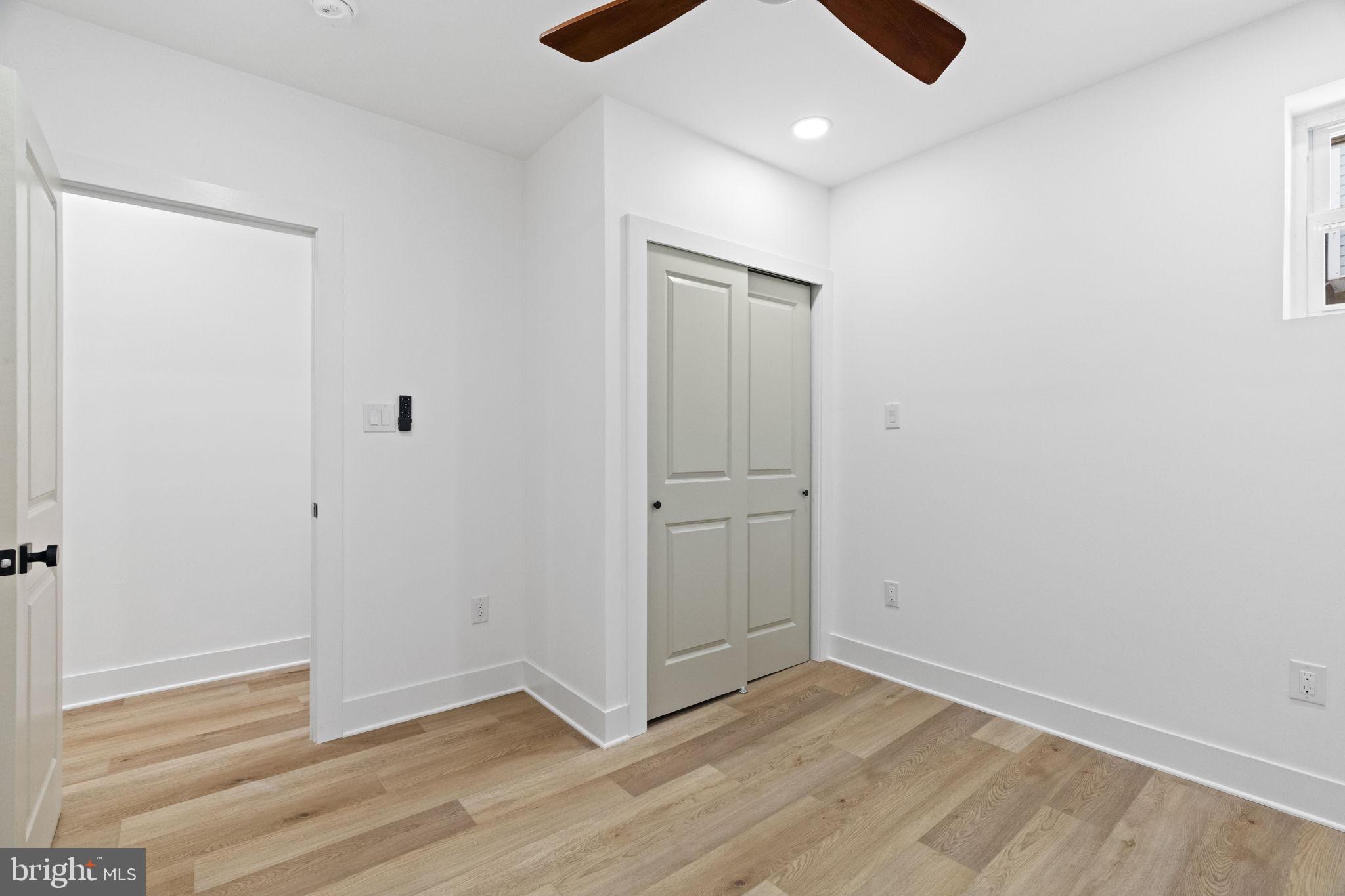 1502 South 52nd Street Philadelphia, PA 19143 - Photo 17 of 34 an empty room with wooden floor and windows