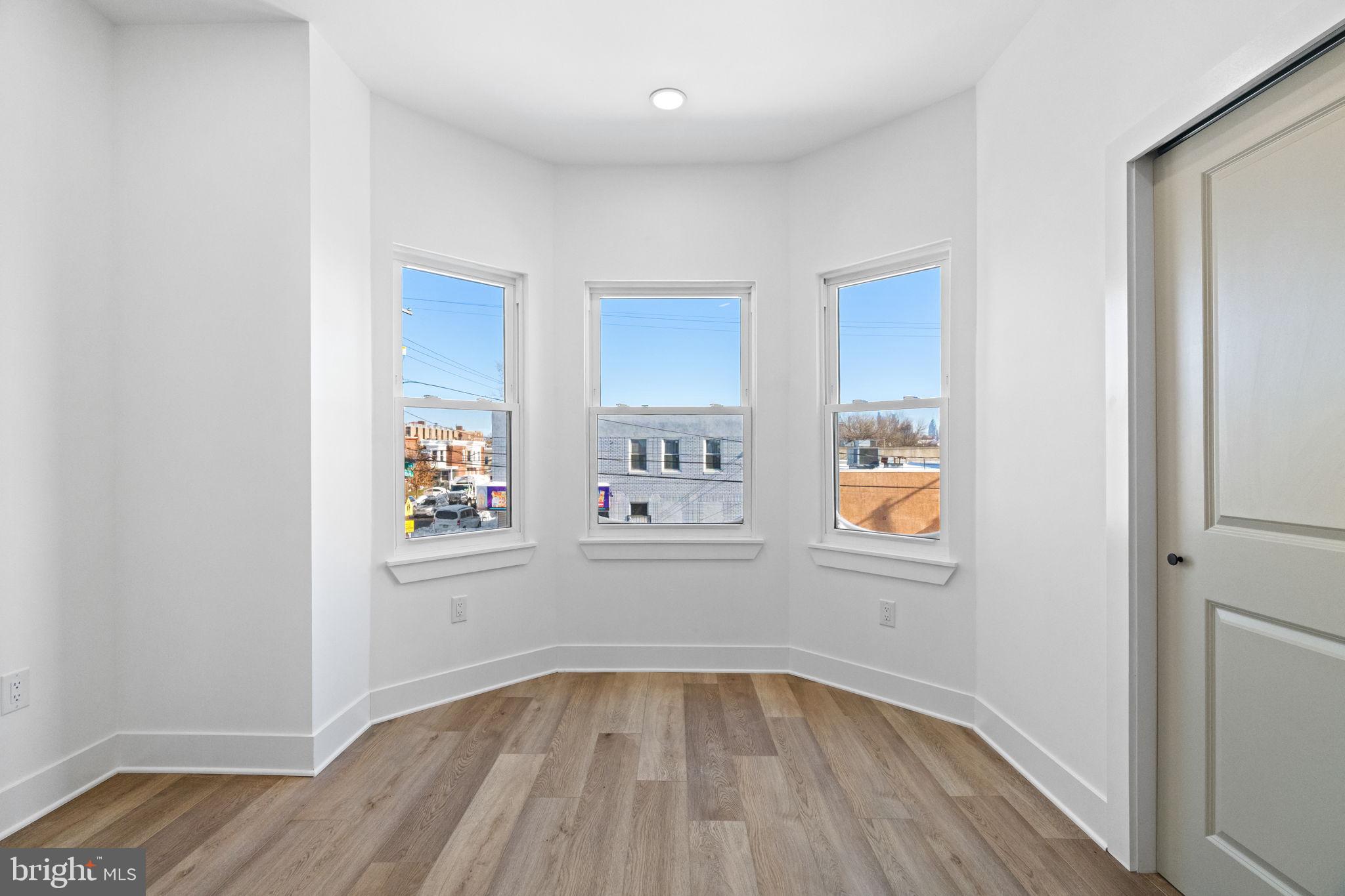 1502 South 52nd Street Philadelphia, PA 19143 - Photo 19 of 34 wooden floor in an empty room with a window