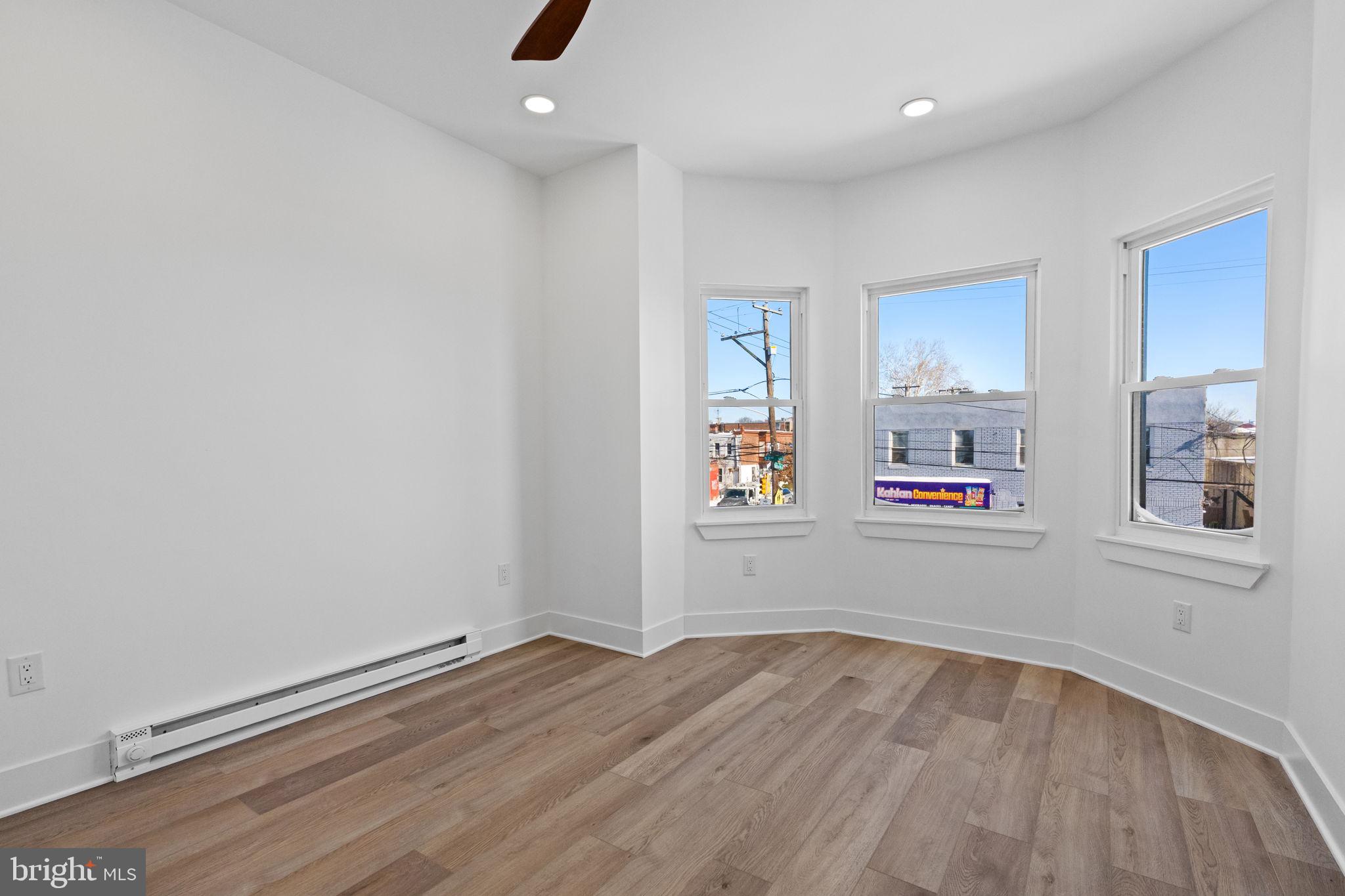 1502 South 52nd Street Philadelphia, PA 19143 - Photo 20 of 34 an empty room with wooden floor and window