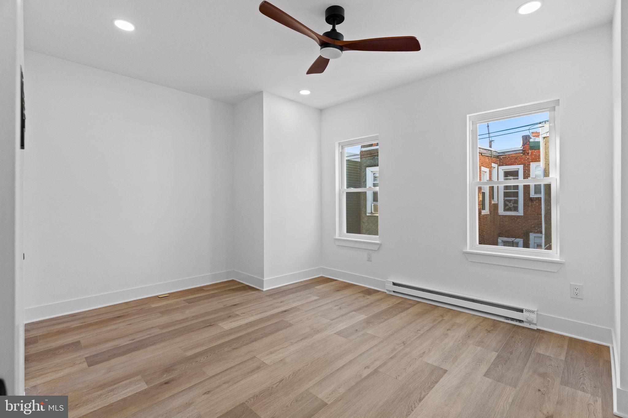 1502 South 52nd Street Philadelphia, PA 19143 - Photo 24 of 34 a view of an empty room with wooden floor and a window
