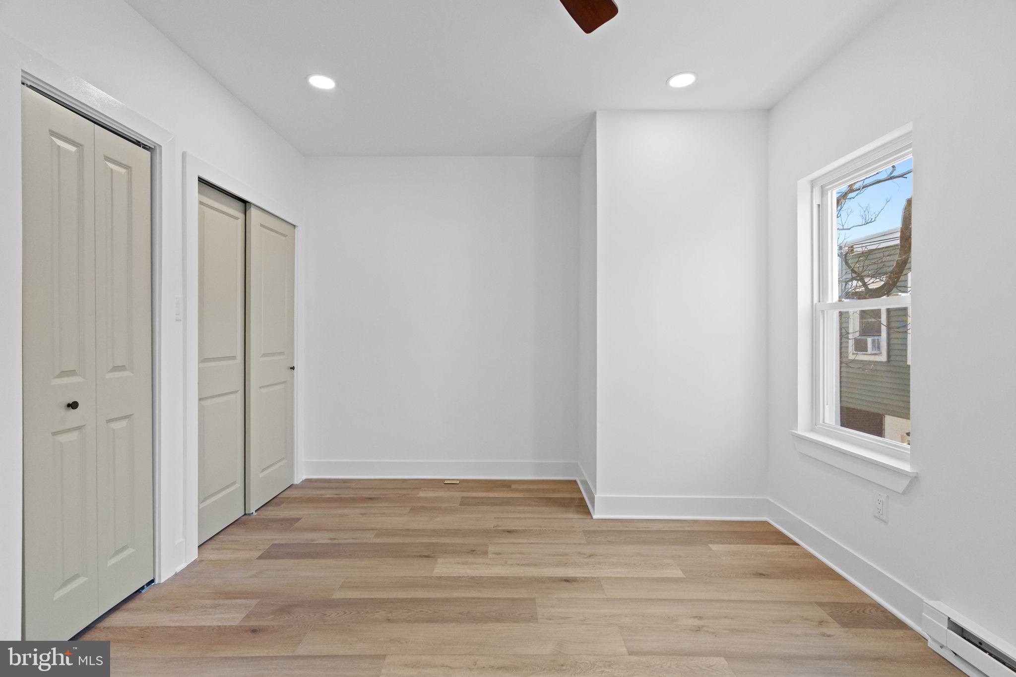 1502 South 52nd Street Philadelphia, PA 19143 - Photo 25 of 34 a view of an empty room with wooden floor and a window