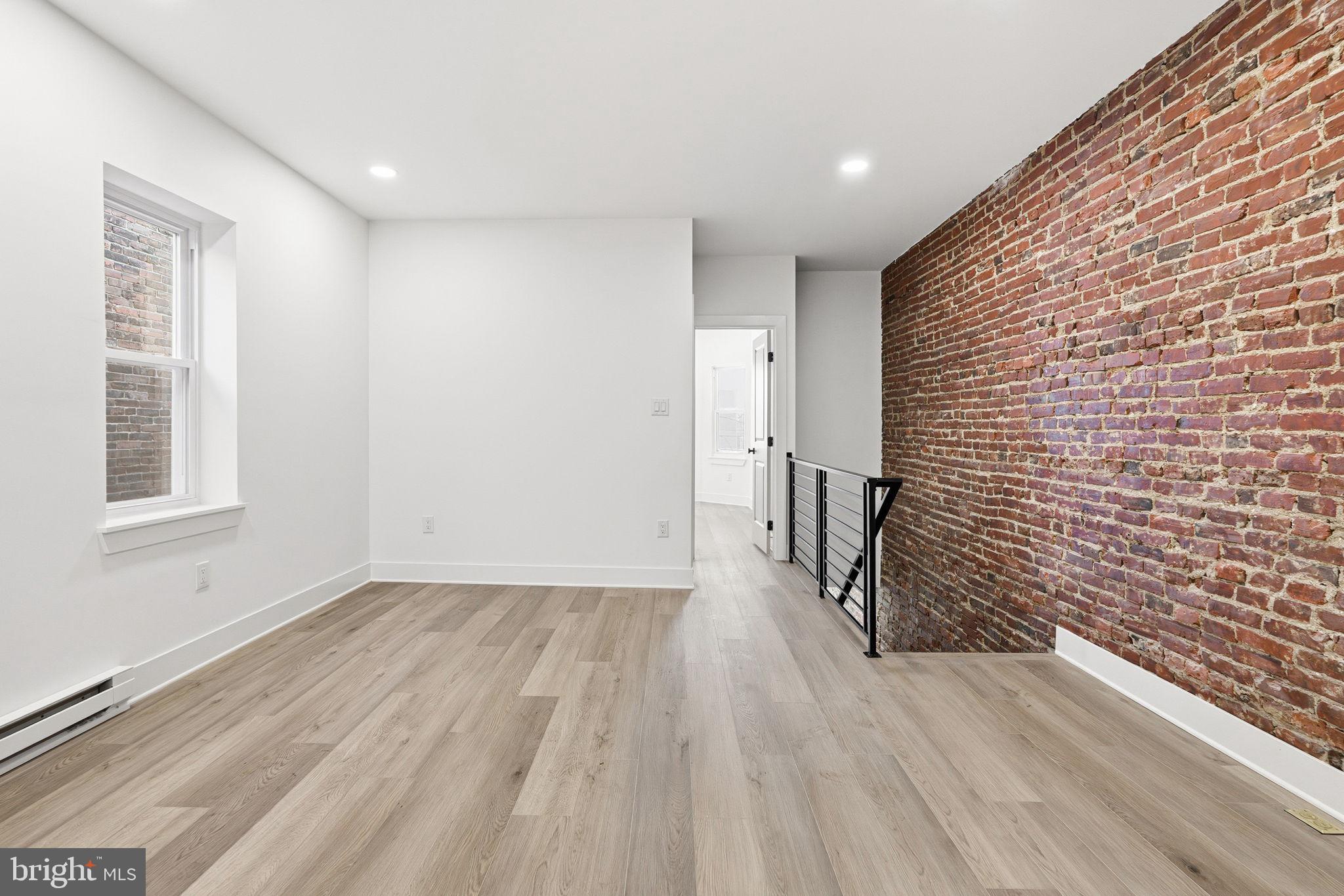 1502 South 52nd Street Philadelphia, PA 19143 - Photo 33 of 34 a view of hallway with wooden floor and stairs