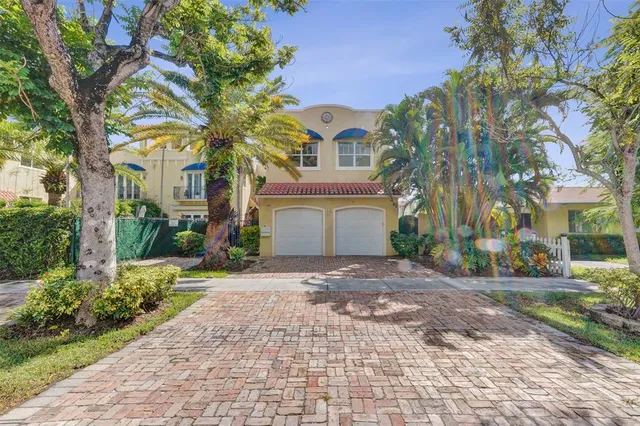 a front view of a house with a yard and a garage