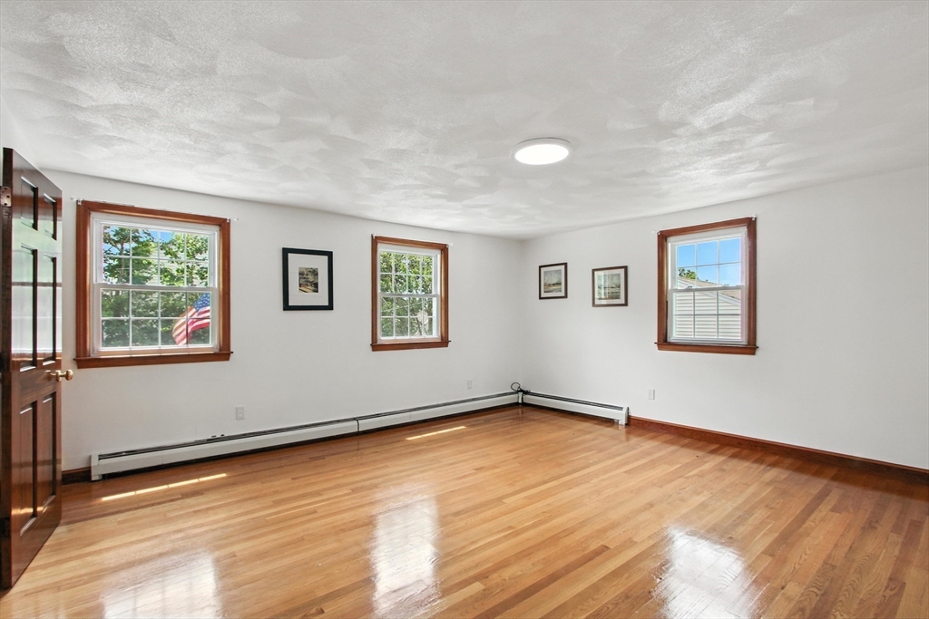 106 Home Park Road Braintree, MA 02184 - Photo 16 of 37 a view of a big room with wooden floor and windows