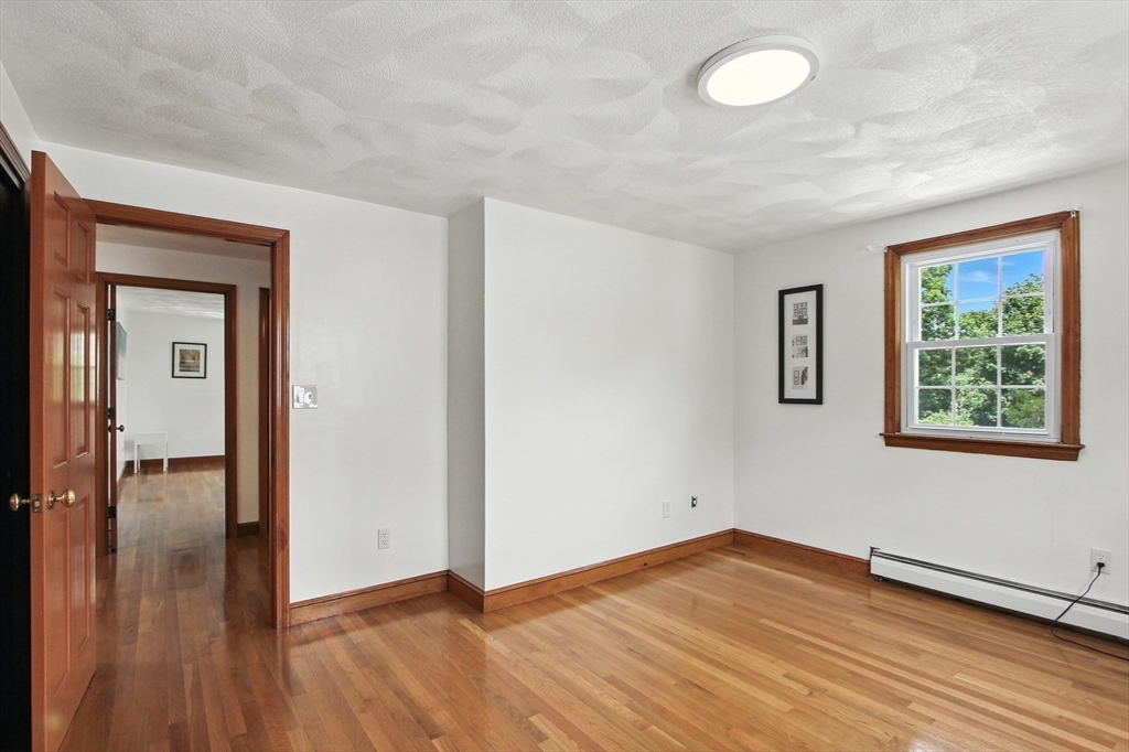 106 Home Park Road Braintree, MA 02184 - Photo 17 of 37 an empty room with wooden floor and windows