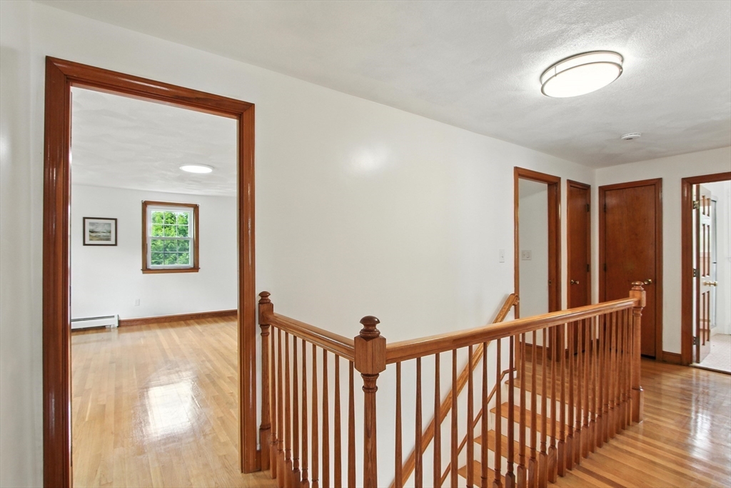 106 Home Park Road Braintree, MA 02184 - Photo 18 of 37 a view of a hallway with wooden floor and a dining room