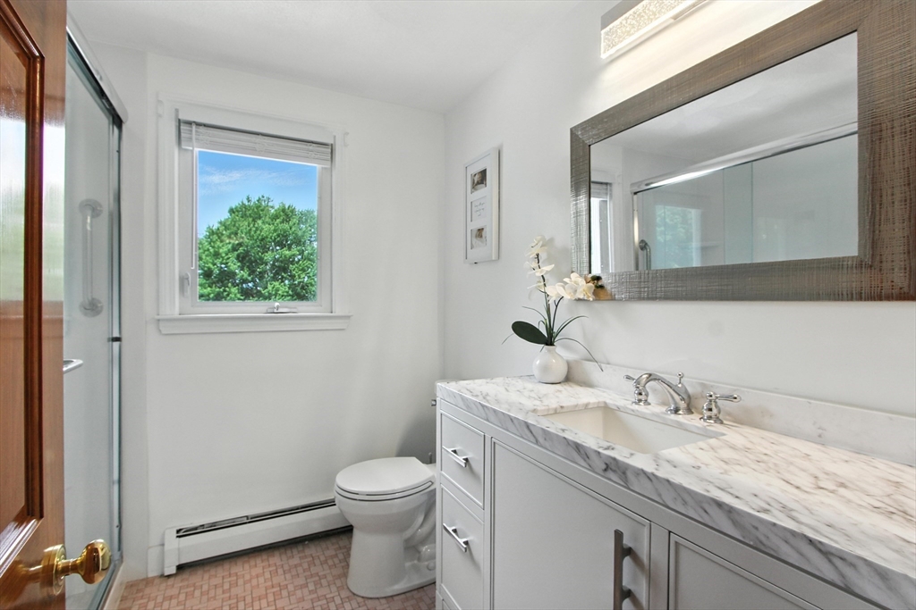 106 Home Park Road Braintree, MA 02184 - Photo 23 of 37 a bathroom with a granite countertop sink a toilet and a mirror