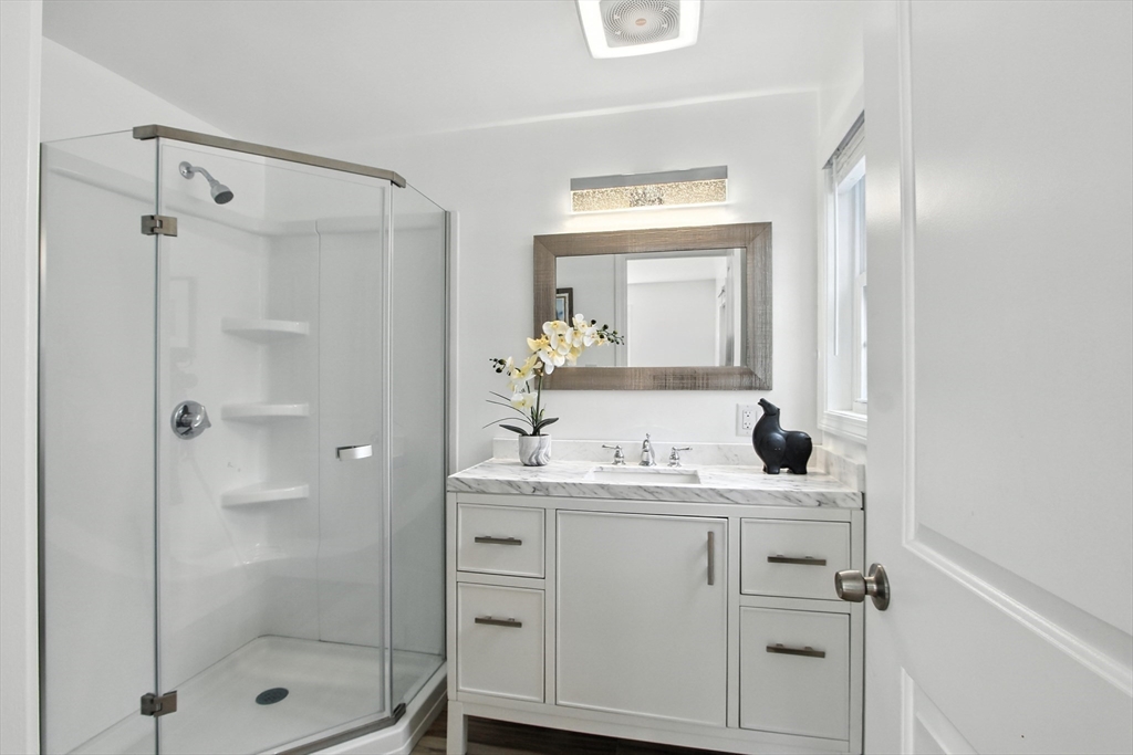 106 Home Park Road Braintree, MA 02184 - Photo 24 of 37 a bathroom with a shower sink and mirror